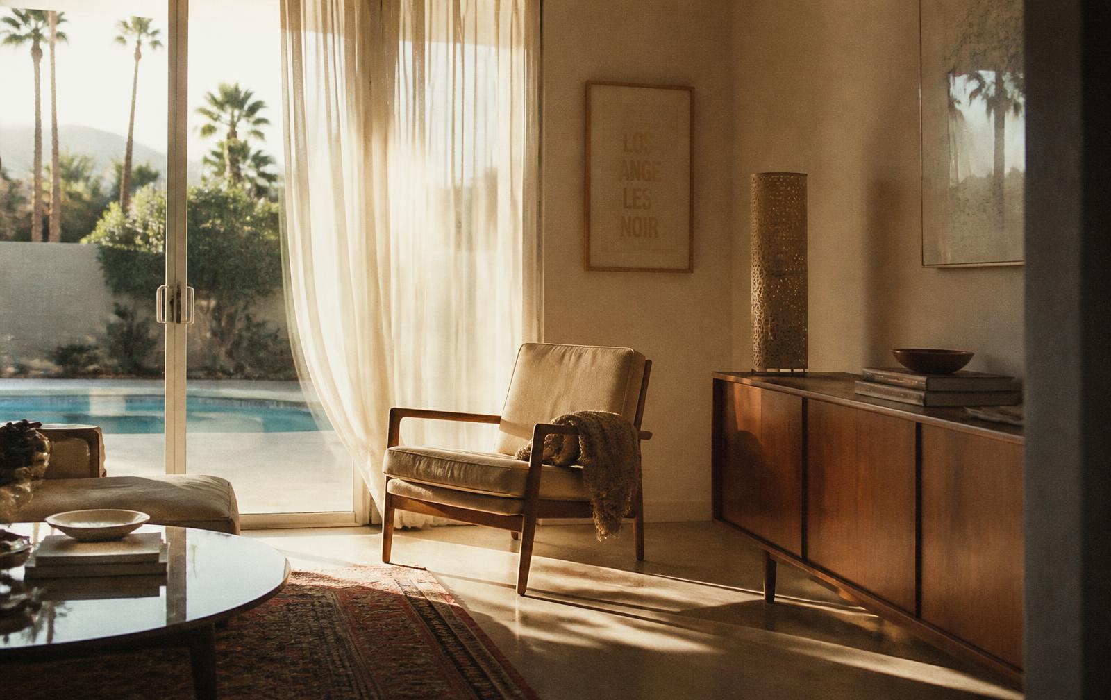 A quiet Southern California living room in late afternoon light with an empty chair